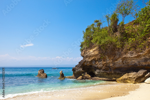 View from a sandy beach on rocks at ocean.Indonesia,Bali..