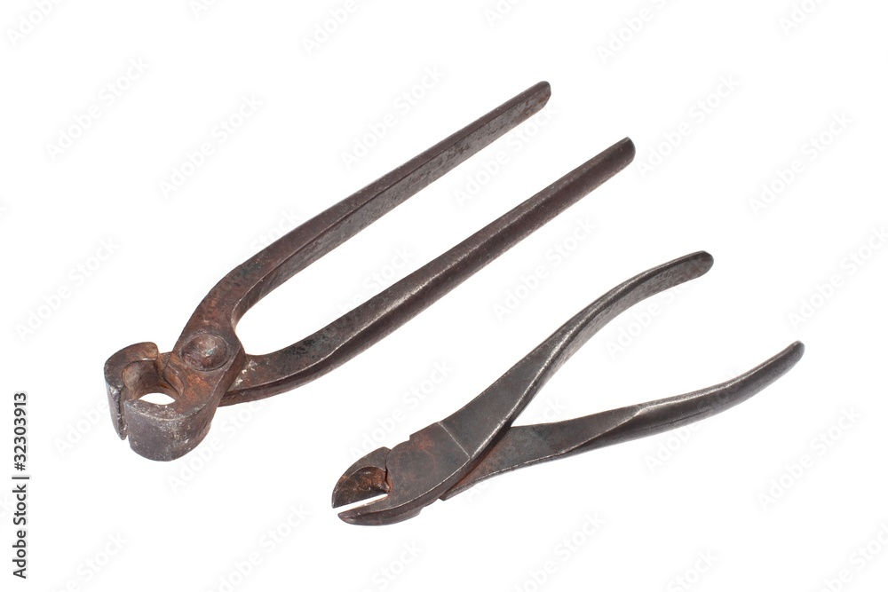 Pairs of old pincers and nippers on a white background