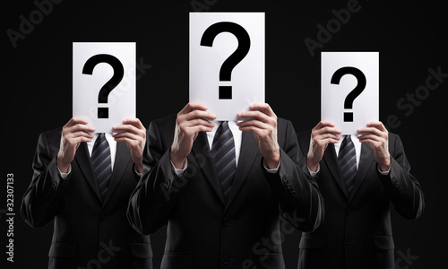 group of business people holding a question mark