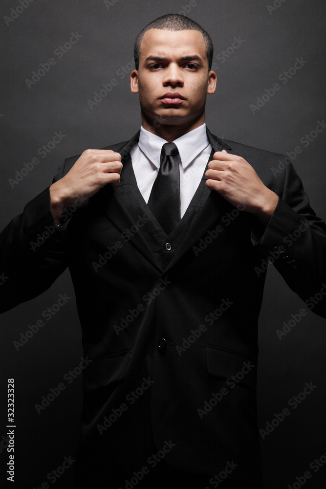 Young African-American businessman in black suit. Young African-American businessman in black suit.
