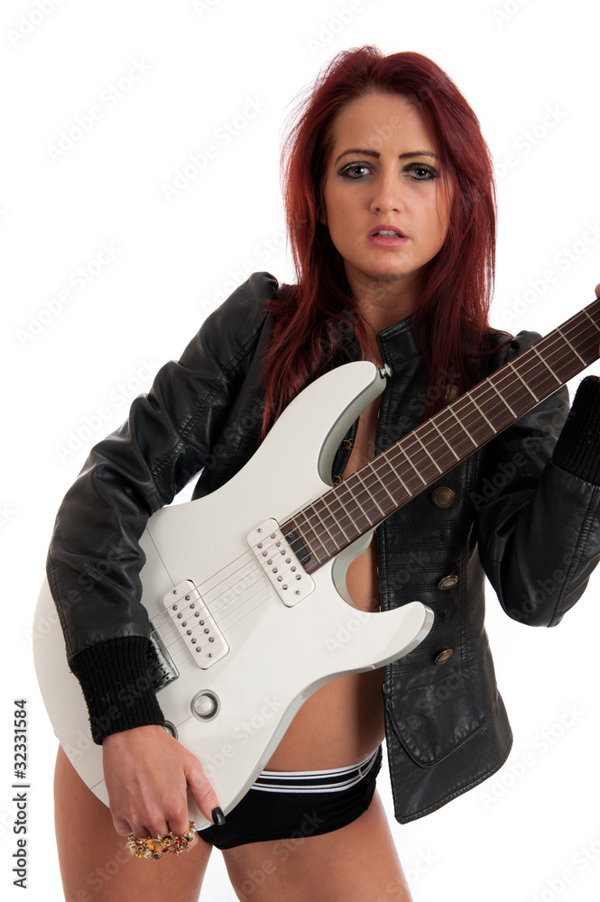 Sexy female with red hair holding guitar isolated Sexy female with red hair holding guitar isolated