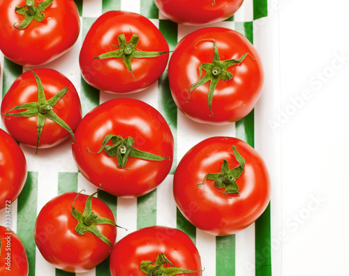 tomatoes on striped tray © Diana Taliun