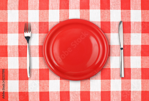 Knife, red plate and fork o...