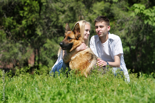 young couple with dog outdoors © Alena Yakusheva