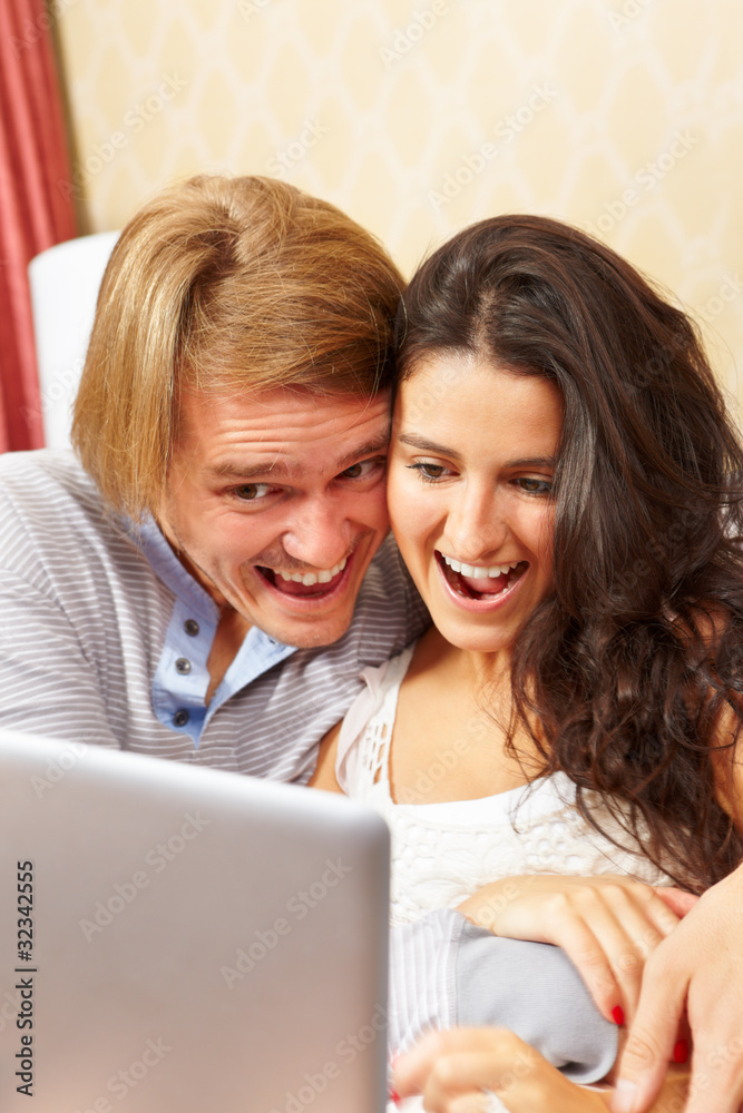 Happy couple spending with laptop Happy couple spending with laptop