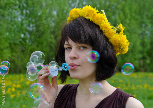 girl blowing soap bubbles