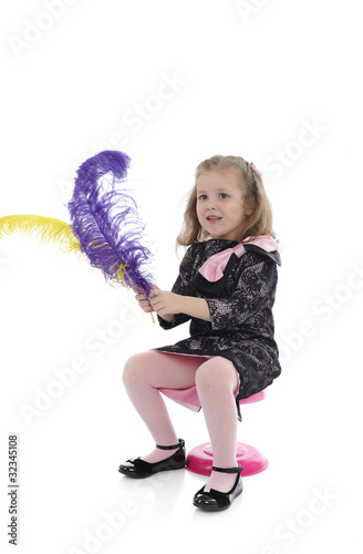 Pretty little surprised girl in black elegant party dress playin