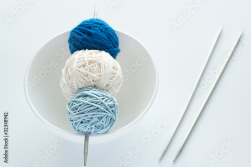 Colored balls of wool for knitting and needles photo