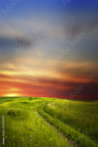 Road in field over sunset