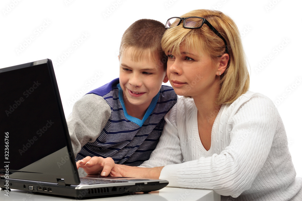 Portrait of adult woman watching as her son doing homework Portrait of adult woman watching as her son doing homework