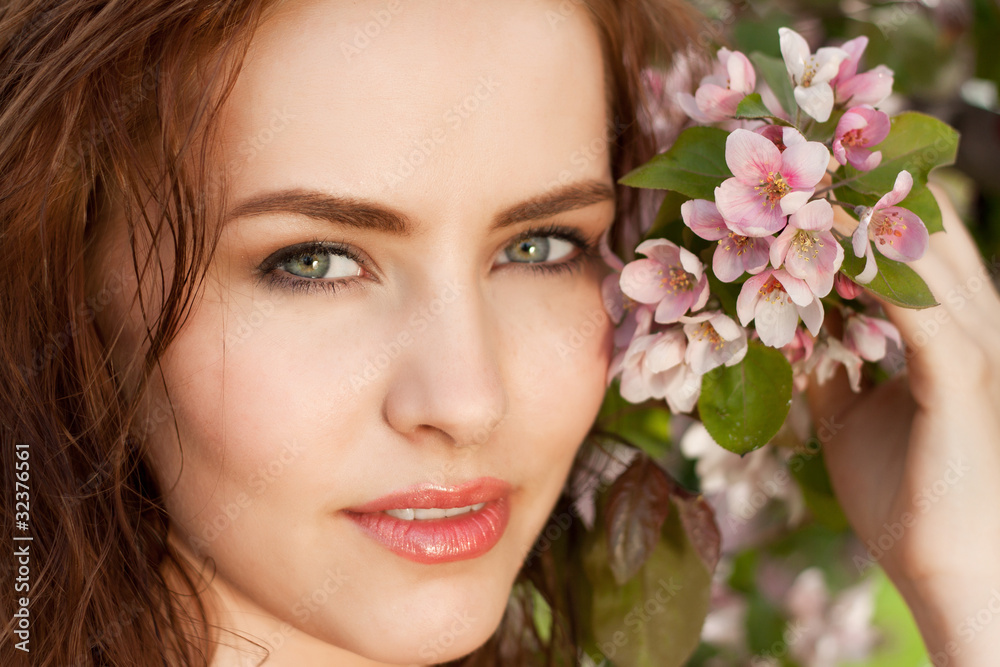 portrait of young lovely woman in spring flowers portrait of young lovely woman in spring flowers