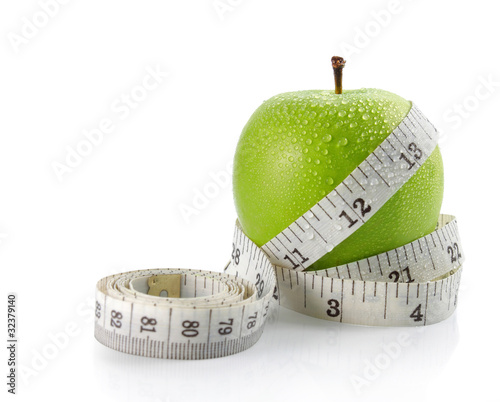 fresh apple with measuring tape
