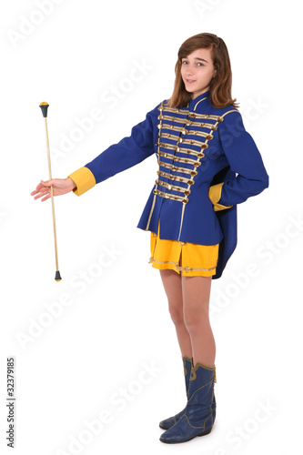 Teenage majorette in uniform twirling a baton photo