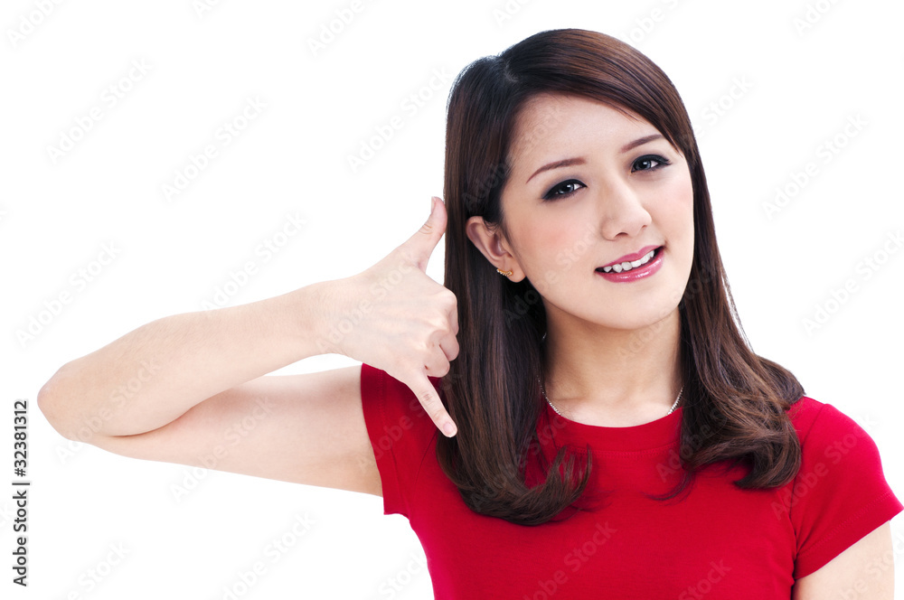 Beautiful young woman making a call me gesture Beautiful young woman making a call me gesture