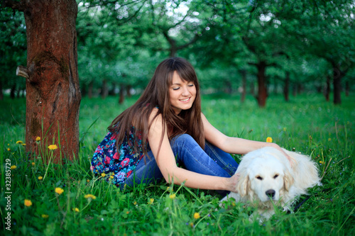 Girl and retriever in park