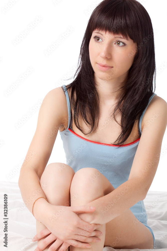 attractive woman sitting on bed