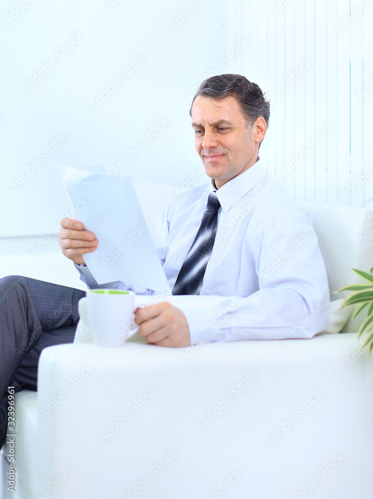 A businessman sited on a sofa A businessman sited on a sofa