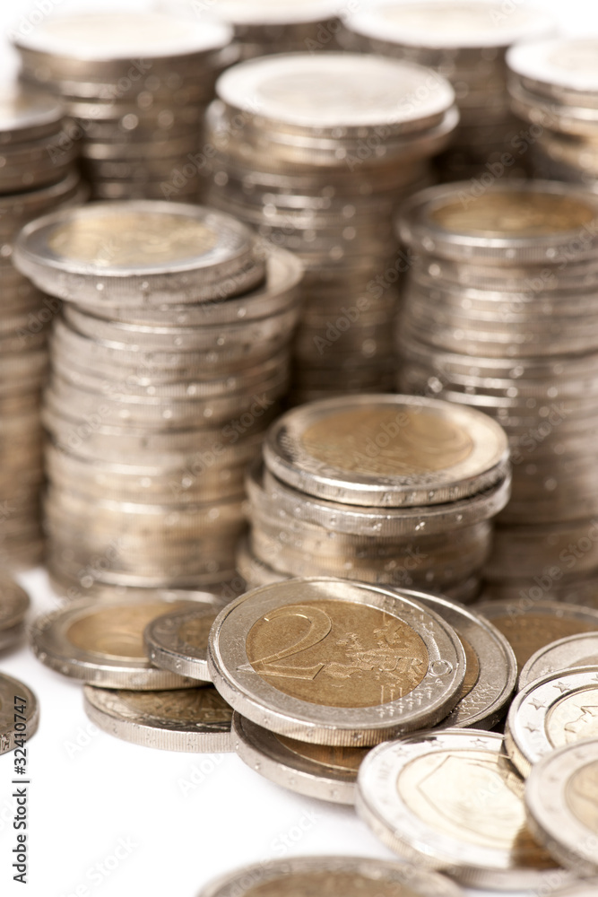 Close-up stacks of 2 Euros Coins in front of white background Close-up stacks of 2 Euros Coins in front of white background
