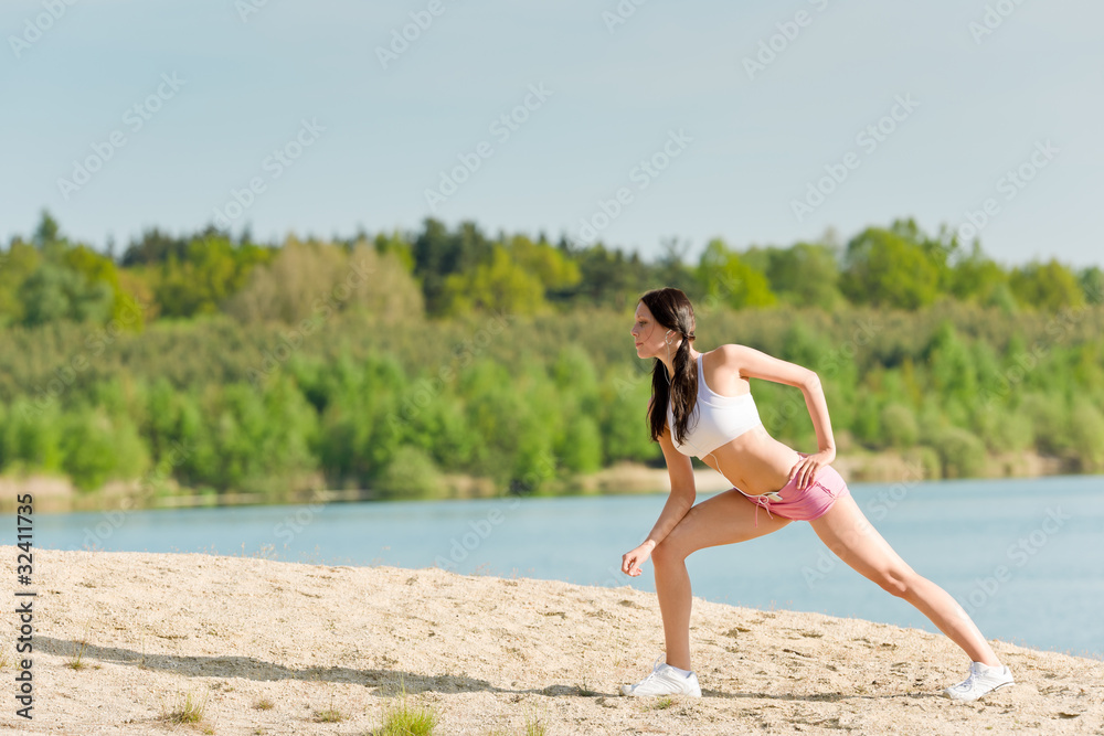 Fototapeta premium Summer sport woman stretching on beach
