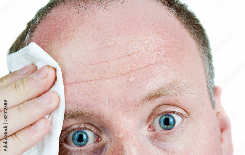 Sweaty man using tissue
