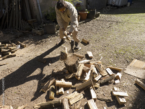 caucasian man chopping wood