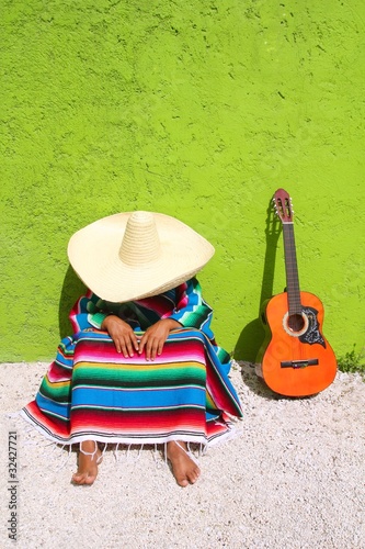 Typical mexican sombrero man sitting photo