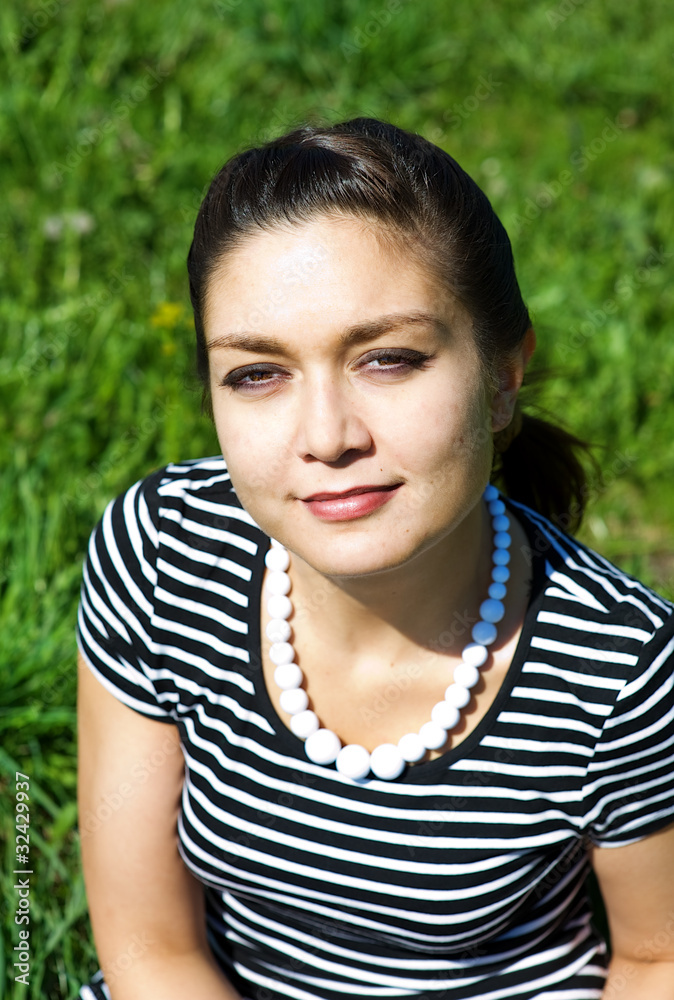 Oriental girl on the grass field Oriental girl on the grass field