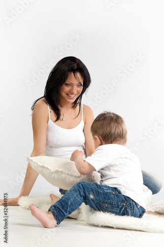 Young beautiful woman and her son having fun together