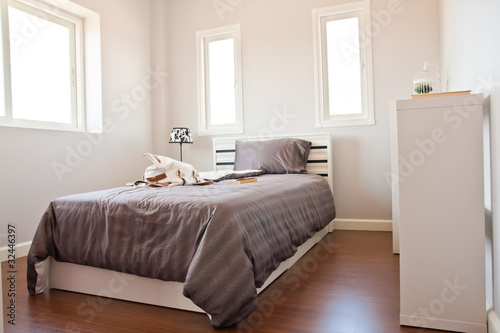 White bedroom with brown sheet bed