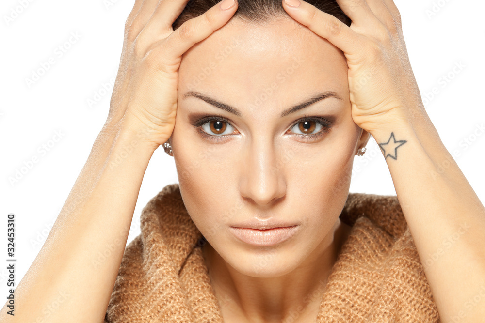 Portrait of young woman troubling and holding her head