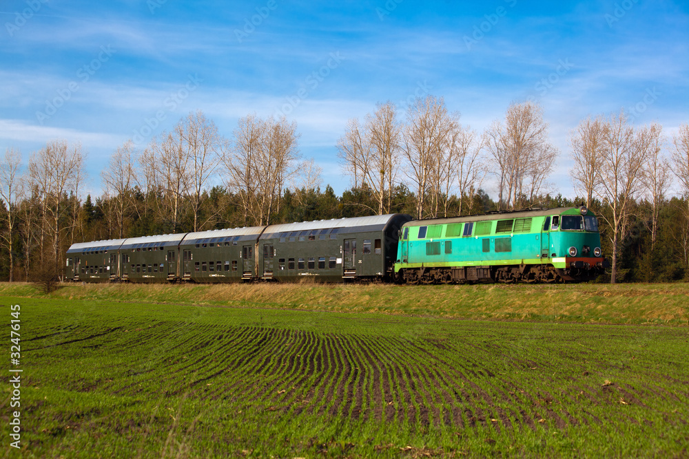 Passenger train passing through countryside Passenger train passing through countryside