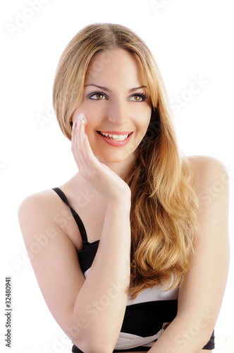 Pretty woman applying moisturizer, isolated