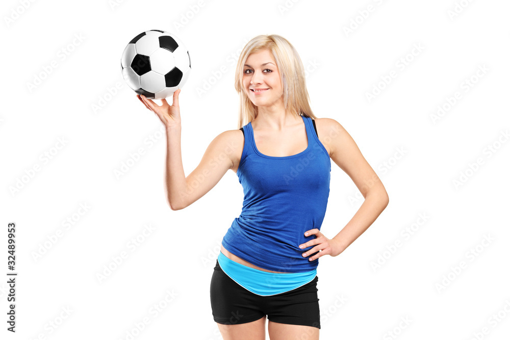 Attractive female holding a football