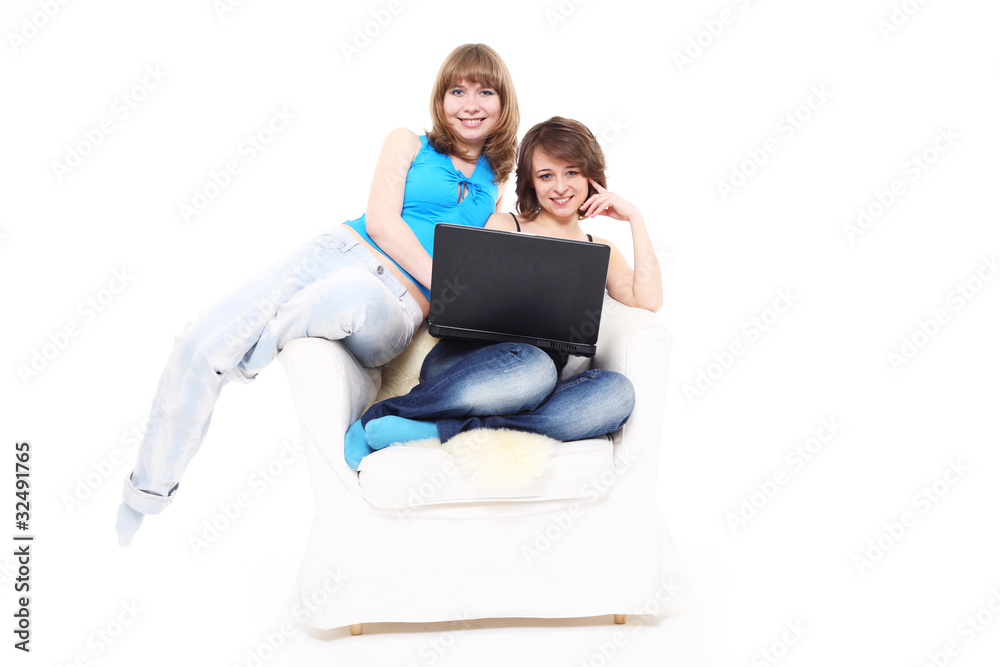 Two girls work on a laptop