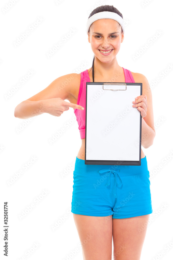 Smiling young fit girl pointing finger at blank clipboard Smiling young fit girl pointing finger at blank clipboard