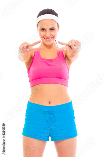 Smiling confident young  girl in sportswear showing victory © Alliance