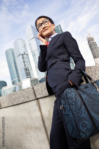 Businesswoman, skyscraper background