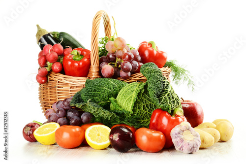 Raw vegetables in wicker basket isolated on white