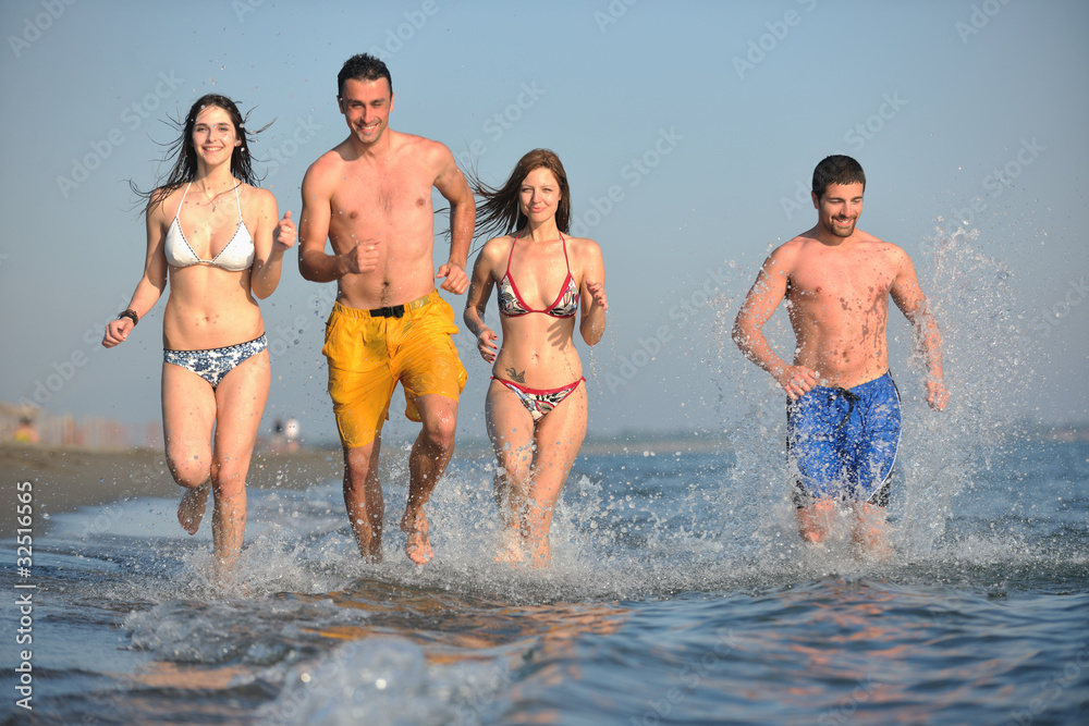 happy people group have fun and running on beach happy people group have fun and running on beach