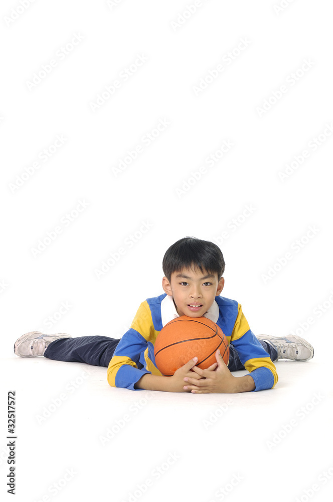 A happy asian little boy relaxing with his basketball, A happy asian little boy relaxing with his basketball,