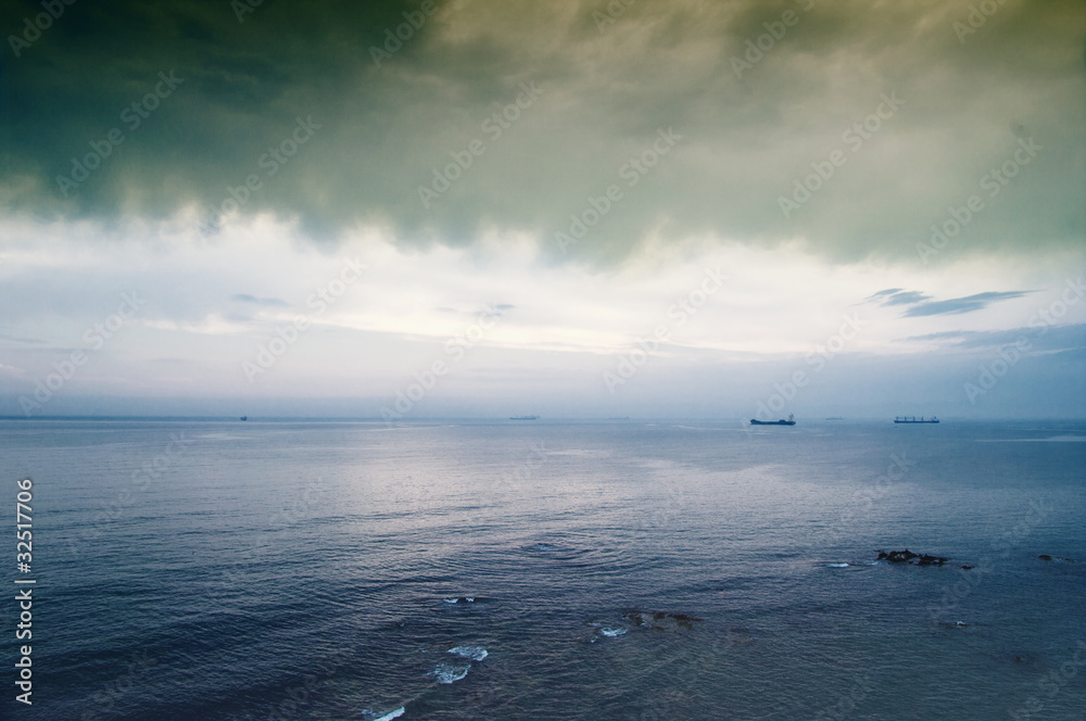 Fototapeta premium Storm clouds over the island in sea