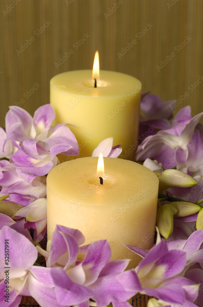 Candle and pink orchid a brown backdrop