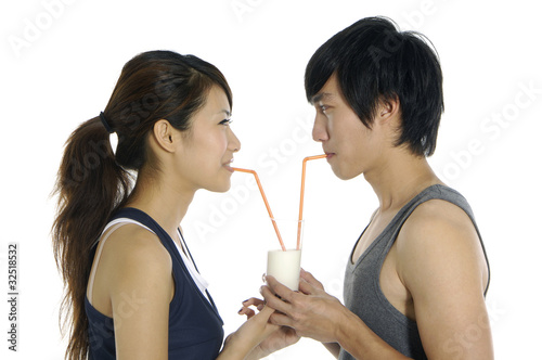 close up young love couple drinking milk.