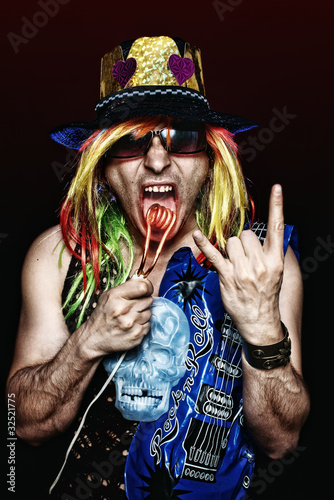 Crazy rock star burning his tongue with hot electric heater photo