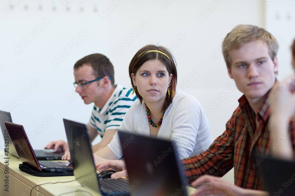 young, pretty female college student sitting in a classroom young, pretty female college student sitting in a classroom