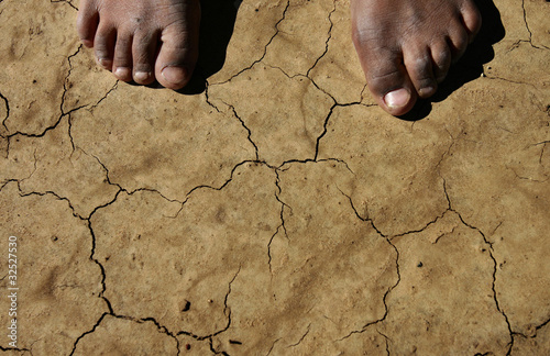 Cracked earth and feet