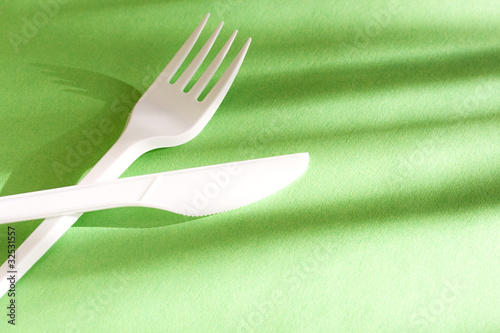 Fork and knife isolated on green background