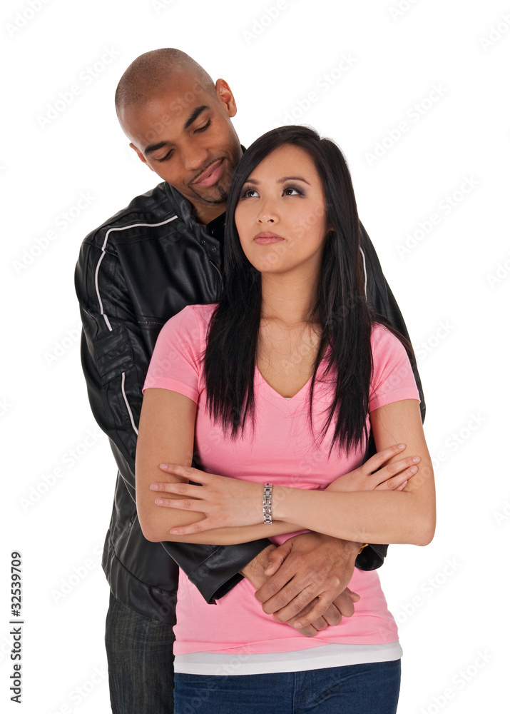 Naklejka premium Affectionate guy embracing sceptical-looking girl