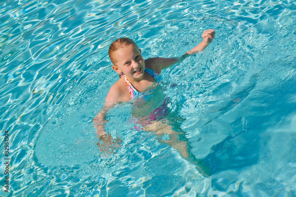 teen girl enjoying in swim pool