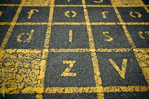 Yellow Painted Letters on Asphalt
